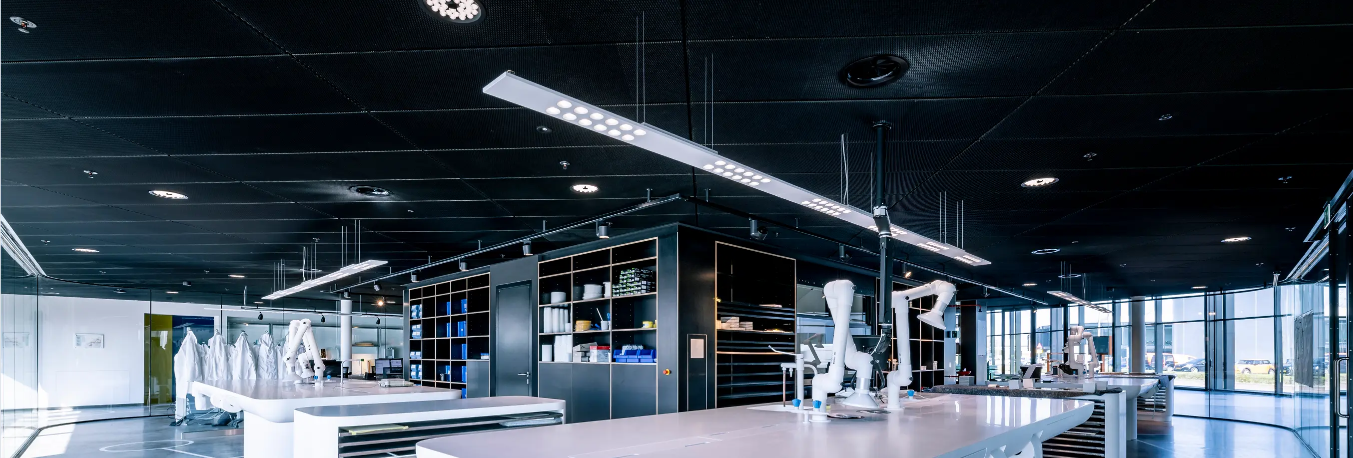 The color of D4 downlights and K9 emergency lighting was adjusted to match the black ceiling, seamlessly integrating the luminaires into the ceiling